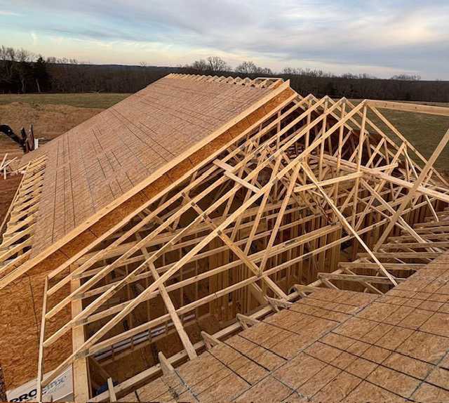 Detailed view of high-quality wooden roof trusses manufactured and installed by Lakeside Truss Company during the framing stage of a new Missouri building project. This authentic photo illustrates the precision engineering, structural strength, and expert craftsmanship that ensure faster, more reliable construction for builders across the state.